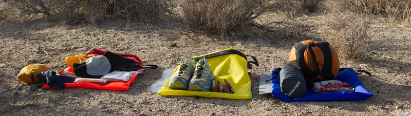 Drop bags carrying dry shoes and socks, among other things to keep your feet dry and prevent maceration