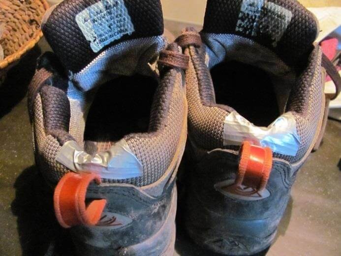 holes in the back of shoes patched with duct tape